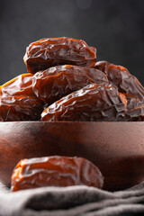 Dried delicious date fruit on vintage stone background