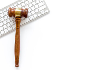 Wooden judge gavel and keyboard, top view. Lawyer desktop