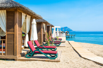 Fototapeta premium Wooden beach pavilions on the shore of a sandy beach