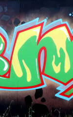 Colorful background of graffiti painting artwork with bright aerosol outlines on wall. Old school street art piece made with aerosol spray paint cans. Contemporary youth culture backdrop