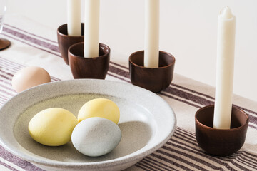 Easter place setting with candles and multi colored eggs - 748940869