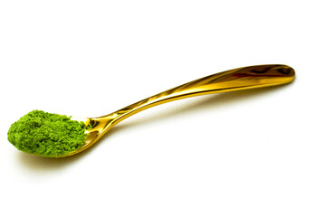 Green tea extract with golden spoon isolated white background