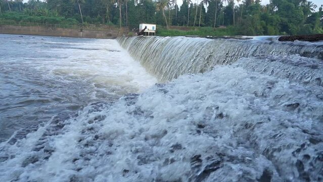 A beautiful waterfall from a check dam at Kerala India. Beautiful view of pure white water flowing through the rocks