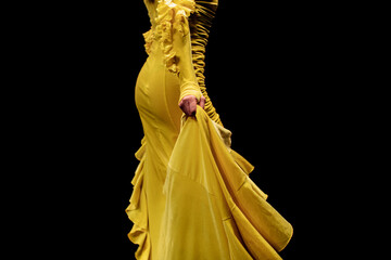 Yellow velvet dress with long hem. Female clothing elegant outfit. Side view