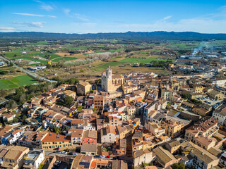 Fototapeta na wymiar Take a virtual tour above Llagostera and witness the timeless charm of Spain's medieval villages along the picturesque Costa Brava. 