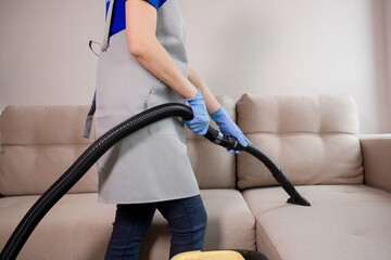 cleaning hotel rooms, vacuuming the sofa