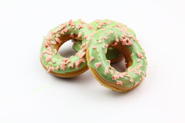 Sweet strawberry glazed donuts with sprinkles on white background, Delicious colorful donuts isolated on white background With clipping path.