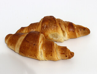 Freshly baked croissants, isolated on white background. 