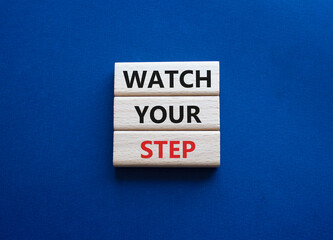 Watch your Step symbol. Concept words Watch your Step on wooden blocks. Beautiful deep blue background. Business and Watch your Step concept. Copy space.