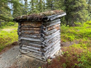 Log outhouse with sod roof. At Carrithers cabin near Dick Proenneke's cabin on Upper Twin Lake in...