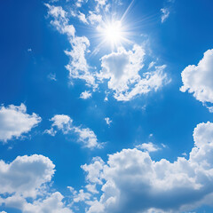 Bright blue sky with puffy clouds on a clear sunny day with sun in the sky