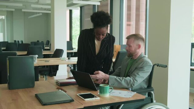 Diverse coworkers discussing business tasks at work