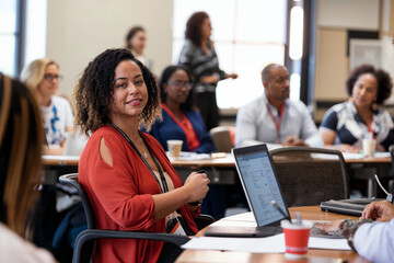 Candid capture of an engaged African American woman during a business training session, highlighting DEI in the workplace.

