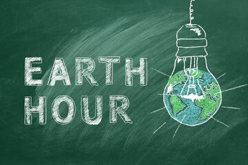 Light bulbs with lettering EARTH HOUR hand drawn in chalk on a school greenboard. Save the World. Save our planet.