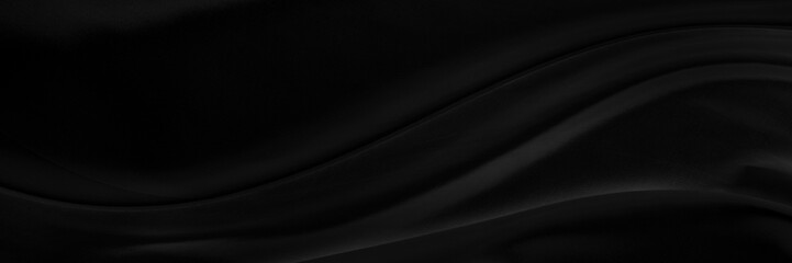 Black gray satin dark fabric texture luxurious shiny that is abstract silk cloth panorama background with patterns soft waves blur beautiful.
