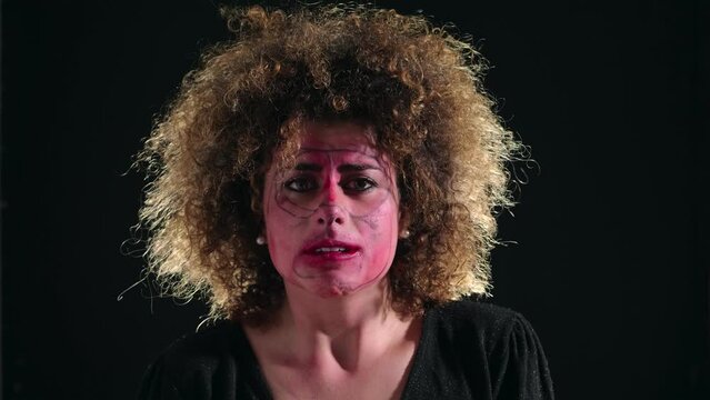 woman with psychic problems runs her hands on her dirty face 