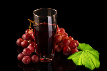 Red grape with leaf and juice in glass  isolated on black background. - 748962814