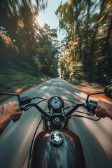 Closeup of two hands on motorcycle handlebars, motorcyclist on paved road.