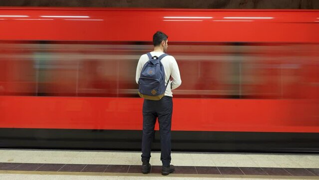 A Man Waiting for Metro in Helsinki. A man waits on the platform as the Helsinki Metro train arrives, capturing motion and the urban station atmosphere.