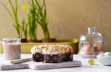 Traditional Italian Easter bread colomba topped with sliced almonds and icing, served with a side...