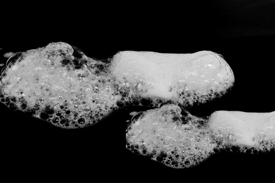 Soap foam isolated on black background. Realistic white washing foam from soap or shampoo or Shaving cream. soap bubble  
