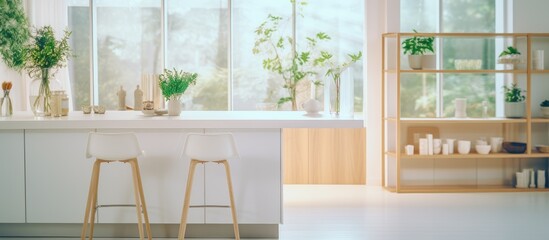 The kitchen features two sleek stools positioned in front of a window, creating a cozy seating area in the bright and minimalist space. The interior design includes an island table, open cabinets with