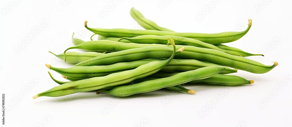 Poster a collection of fresh green beans arranged in a heap on a clean, white surface. the vibrant green po