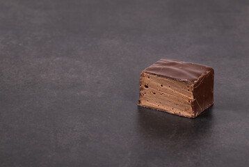 Delicate dessert. Chocolate souffle in chocolate glaze. Bird's milk. Dark gray background. Close-up. Copy space	