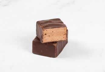 Vegan Delicate dessert. Chocolate souffle in chocolate glaze. White background. Close-up	