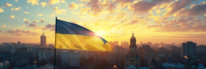 Ukrainian flag waving against a backdrop of Kyiv's historical architecture at sunrise