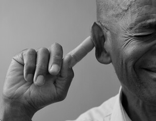 man suffering from deafness and hearing loss with people stock image stock photo	
