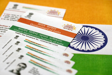Indian Aadhaar card from Unique Identification Authority of India on Indian flag close up