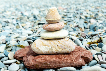 Fototapeta na wymiar Harmonious Stack of Zen Stones on Pebbled Beach