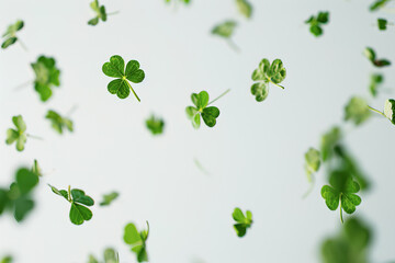 Fototapeta na wymiar Close up of a few lucky clover flying on white background
