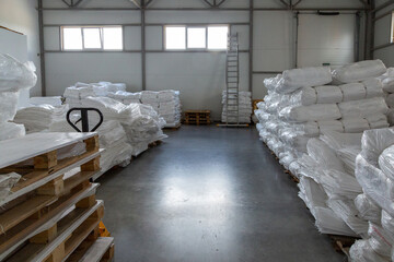 Factory warehouse with new white polypropylene bags ready to ship to customer.