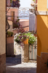Fototapeta na wymiar Narrow street typical for Italian towns, Castelmola, Sicily, Italy