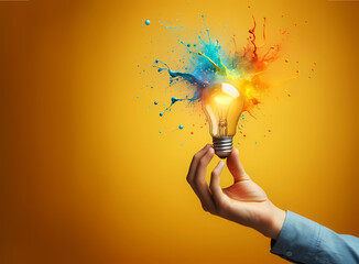 An electric light bulb, bursts with colorful splashes and dust against a white background. This dynamic image symbolizes the spark of new ideas and the explosion of creativity. - obrazy, fototapety, plakaty