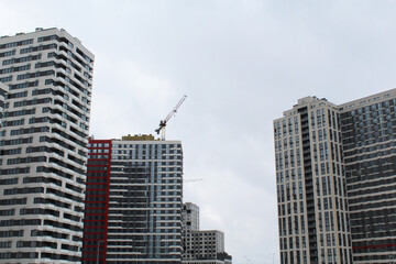 construction with a crane of a modern office building against the background of high-rise buildings in the city of Kyiv, Ukraine
