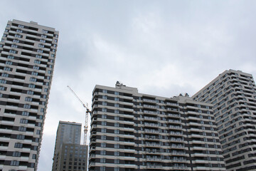 Naklejka premium construction with a crane of a modern office building against the background of high-rise buildings in the city of Kyiv, Ukraine