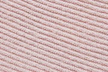 Ribbed light pink soft jersey fabric pattern texture with metallic threads as background
