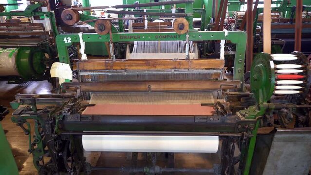 Lowell, Massachusetts: Lowell National Historical Park celebrates era of textile manufacturing during the Industrial Revolution. Boott Cotton Mills Museum recreated weave room. Weaving machine bobbin.
