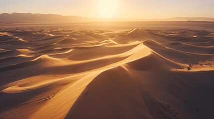 Desert dunes at sunrise from an aerial viewpoint. - obrazy, fototapety, plakaty