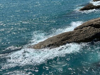 Sea waves crashing on rocks.