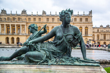 Fototapeta na wymiar Versailles, France - Dec. 28 2022: The bronze statue in the garden of Versailles Palace in France