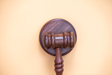 Judge's gavel on yellow background