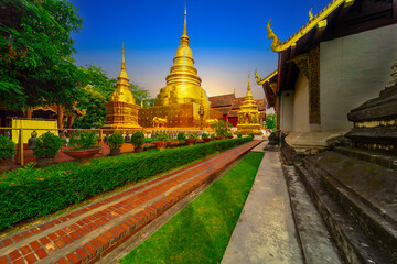 Fototapeta premium Beautiful Wat Buddhist temples in Chiangmai Chiang mai Thailand. Decorated in beautiful ornate colours of red and Gold and Blue. Lovely sunset