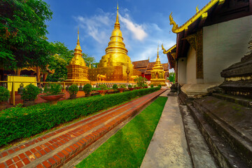 Fototapeta premium Beautiful Wat Buddhist temples in Chiangmai Chiang mai Thailand. Decorated in beautiful ornate colours of red and Gold and Blue. Lovely sunset