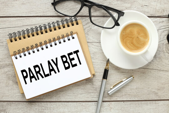 glasses and a cup of coffee on the work table. text PARLAY BET