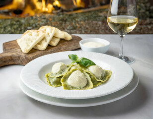 Spinach ravioli with white cream sauce on a white plate.