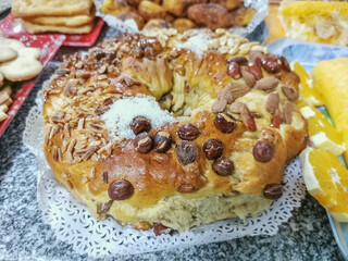 View of a portuguese king cake, or Bolo Rei, traditional Portuguese, baked from a soft, white dough, with raisins, various nuts and crystallized fruit, typical of Christmas and New Year